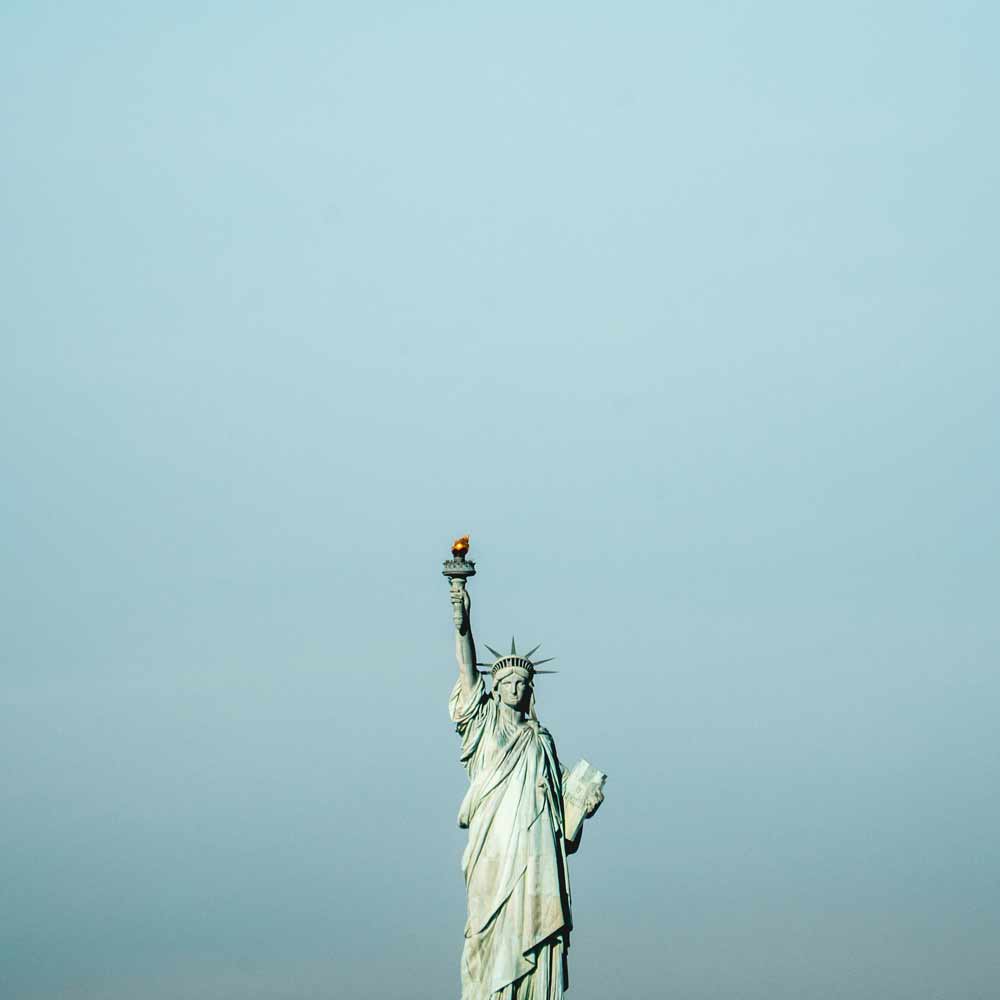 The Statue of Liberty against a pale sky